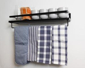 a shelf with plates and cups on a wall at Thena Hotel - Spacious Studio in Philadelphia