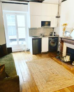 un soggiorno con cucina completa di piano cottura e forno di Electra mini-studio a Parigi