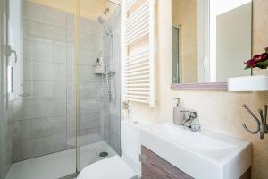 a bathroom with a shower and a sink and a toilet at SAGRADA FAMILIA C&D Lovely Apartment in Barcelona