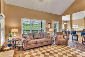 a living room with a couch and a chair at Paradise on the Fairway in Reeds Spring
