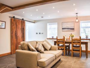 a living room with a couch and a table at Y Parlwr in Kidwelly