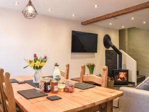 a wooden table in a living room with a fireplace at Y Parlwr in Kidwelly