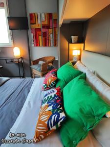 a bedroom with a bed with pillows on it at La mia seconda casa ad Aci Castello in Aci Castello