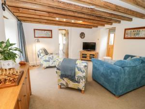 a living room filled with furniture and a chessboard at The Old Stable in Conwy