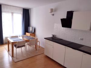 a kitchen with a table and chairs and a kitchen with a counter at Apartament Zdrój in Krzeszowice