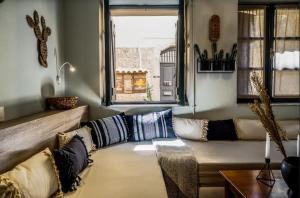 a living room with a couch and a window at Ink Hotels House of Europe in Rethymno Town