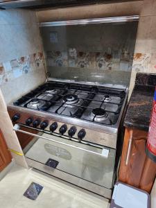 a stove top oven sitting in a kitchen at 2 bedroom luxury beach apartment with Full seaView in Ajman 
