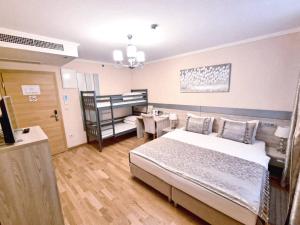 Postelja oz. postelje v sobi nastanitve Benjamin Hotel