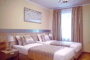 Postelja oz. postelje v sobi nastanitve Benjamin Hotel