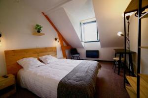 a bedroom with a large bed and a window at Le Permayou in Accous