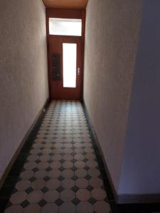 a hallway with a door and a tile floor at Ferienwohnung Enz 