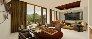 InterContinental Chennai Mahabalipuram Resort في مهاباليبورام: غرفة طعام وغرفة معيشة مع طاولة وكراسي