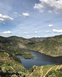 an aerial view of a lake in the hills at Quinta Vila Rachel - Winery in São Mamede de Riba Tua