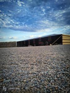 a group of train cars parked next to a building at Apadi camp in Coraya Bay