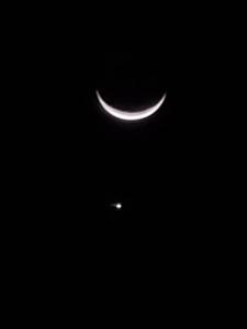 a crescent moon and a small object in the sky at Apadi camp in Coraya Bay