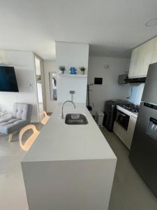 a kitchen with a white counter top in a room at Infinity Blue - Playa Dormida in Santa Marta