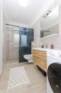 a bathroom with a sink and a toilet and a mirror at Blue moon Split Apartment in Split