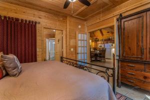 a bedroom in a log cabin with a bed and a dining room at Ole Hickory w/Firepit HotTub in Ridgedale +31 photos
