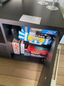 a black table with books on a shelf at Naturskøn landidyl på Ibækgaarden - I egen bolig in Vejle