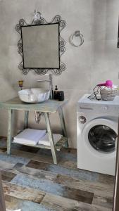 a laundry room with a washing machine and a mirror at Blue house II in Palekastron +13 photos