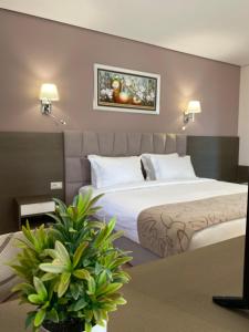 a hotel room with two beds and a table at Doanesia Premium Hotel & Spa in Tirana