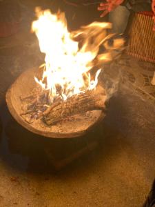 a fire is burning in a pot on the ground at SERENITY CAMPS, MUSSOURIE in Mussoorie