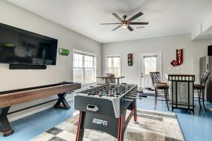 a living room with a game table and a tv at Secluded Branson Escape with Pool and Game Room! in Branson