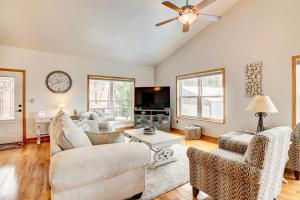 a living room filled with furniture and a ceiling fan at Secluded Branson Escape with Pool and Game Room! in Branson