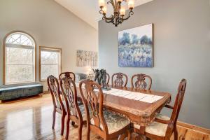 a dining room with a wooden table and chairs at Secluded Branson Escape with Pool and Game Room! in Branson