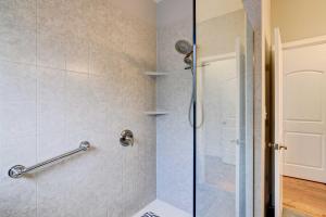 a bathroom with a shower with a glass door at Secluded Branson Escape with Pool and Game Room! in Branson