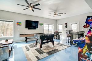 a living room with a piano and a table at Secluded Branson Escape with Pool and Game Room! in Branson