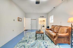 a living room with a leather couch and a table at Secluded Branson Escape with Pool and Game Room! in Branson