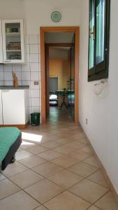 ein Zimmer mit Küche und ein Flur mit einem Tisch in der Unterkunft Casa Vacanze Mari Pintau in Geremèas