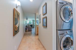 a hallway with a washer and dryer in a house at Kuilima Estates East 41 - Plumeria Tree House in Kahuku