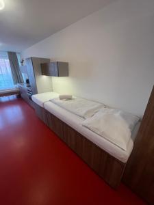 a large bed in a room with a red floor at Palava eu 10 in Pavlov