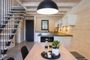 a kitchen and dining room with a wooden wall at Horská chata Belveder in Železná Ruda