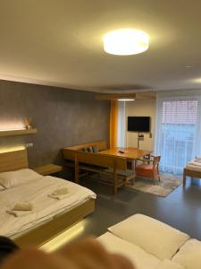 a room with two beds and a table and a television at Palava eu 11 in Pavlov