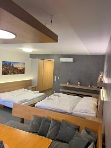 a bedroom with two beds and a table at Palava eu 11 in Pavlov