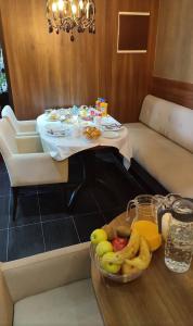 a table with a bowl of fruit on a table at Hotel Swiss Holiday in Budva