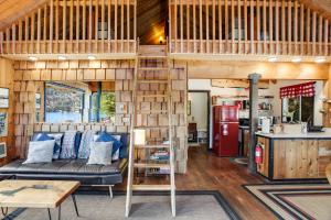 a living room with a loft bed in a tiny house at Lake Sutherland in Port Angeles