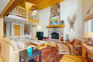 a living room with a couch and a fireplace at Sunset Chalet in Tabernash