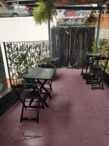 a grill on a patio with two tables and chairs at Varandas da Paulista in São Paulo