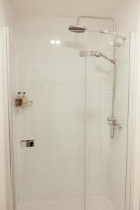 a bathroom with a shower with a glass door at JT Abergwaun hotel in Fishguard