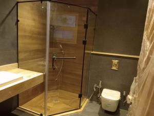 a glass shower in a bathroom with a toilet at Ground floor apartment at October Plaza by Sodic in Madīnat Sittah Uktūbar