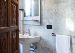 a bathroom with a sink and a mirror at L'antica Lodge in Cremia +20 photos
