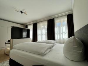 a bedroom with a white bed and a flat screen tv at Luxury Home / 2-Raum-Apartment an der Frauenkirche in Dresden