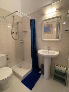 a bathroom with a sink and a shower and a toilet at P&R hostals Can Tort in Tossa de Mar