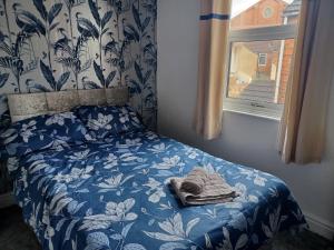 a bedroom with a bed with a blanket and a window at Ripon Street Lincoln in Lincoln