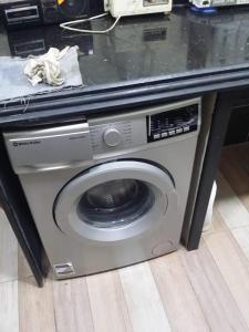 a washing machine under a counter in a room at Rental apartment at Ras El Bar City in ‘Izbat al Jirabī