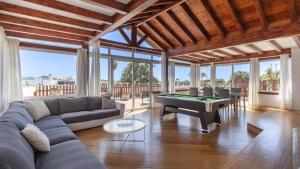 a living room with a couch and a pool table at Luxury Villa Nieve in Caleta De Fuste